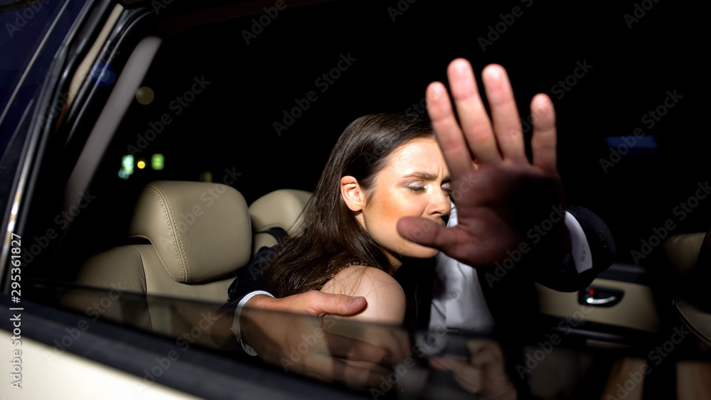 Celebrity couple in car hiding with hand from magazine photographers cameras - obrazy, fototapety, plakaty 