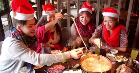 Wall Mural - Happy friends having fun in hot pot restaurant