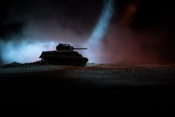 War Concept. Military silhouettes fighting scene on war fog sky background, Silhouette of armored vehicle below Cloudy Skyline At night. Attack scene. Tanks battle.