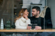 © gorynvd - Beautiful caucasian couple in love drink coffee at cafe. Love and romantic concept.