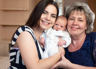 Young mother and grandmother with a baby boy