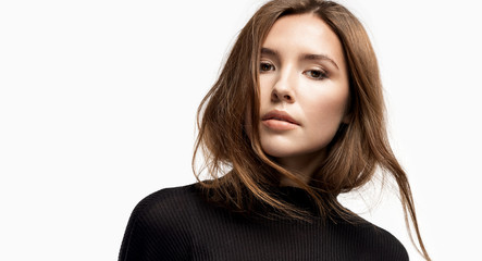 close-up portrait of beautiful girl with perfect skin wearing black pullover. charming young woman w