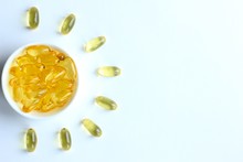 Omega 3 Capsules Laid Out In The Shape Of Sun On White Background. Fish Oil In Pills. Health Support And Treatment. Biologically Active Additives.