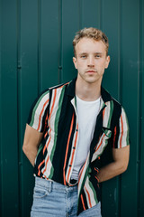 Wall Mural - Young man posing after successful shopping on Black Friday