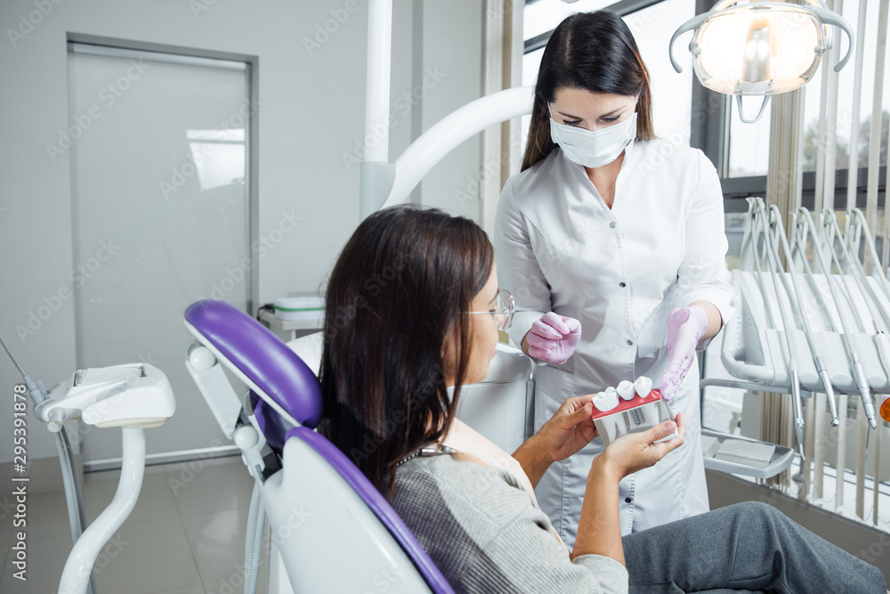 A woman is preparing for a dental examination. Woman having teeth examined at dentists.  - obrazy, fototapety, plakaty 