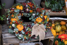 Halloween Wreath Of Pumpkins, Eucalyptus, Poppy Heads With Canvas Bow For Sale In A Flower Shop