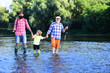 © Volodymyr - Boy with father and grandfather fly fishing outdoor over river background. Man in different ages. Hobby and sport activity.