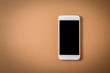Blank smartphone on brown paper background