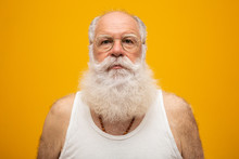Old Man With A Long Beard On A Yellow Background. Senior With Full White Beard. Old Man With A Long Beard With Sadness.