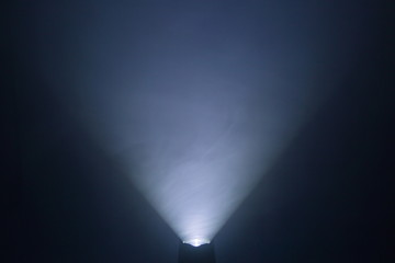 flashlight and light beam in dark mist room at night . abstract projector spotlight white lay growin