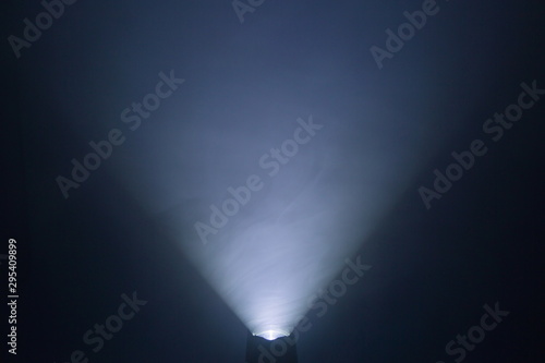 flashlight and light beam in dark mist room at night . abstract projector spotlight white lay growing .