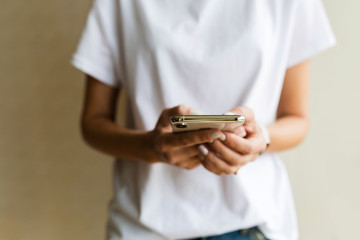 Wall Mural - Hands using a phone texting on smartphone app, searching or social networks concept, hipster woman typing an sms message to her friends. Online shopping, messaging, business concept