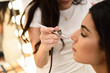 © javiindy - Make-up artist using aerograph making an airbrush make up