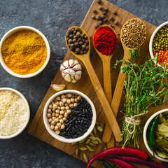 Canvas Print - Spices and herbs, rice and various beans on dark background top view