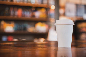 takeaway cup of coffee in coffee shop background