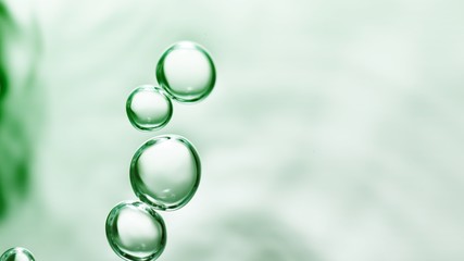 Wall Mural - transparent gas bubbles on water surface. Worms-eye low angle with crystal bubbles in purified water on green background. cosmetic backdrop with copy space