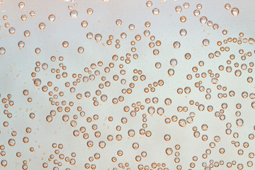 Poster - bubbles of air on glass with shiny gold particles background of small bubbles