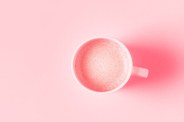 Wall Mural - Cup of coffee on a pink pastel background.