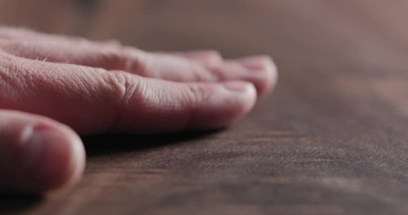 Wall Mural - Slow motion man hand touch oil finished black walnut wood surface