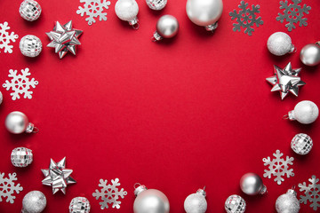 christmas and new year holiday background. xmas greeting card. christmas silver ornaments on red bac