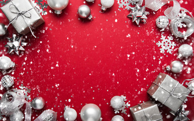 christmas and new year holiday background. xmas greeting card. christmas silver ornaments on red bac