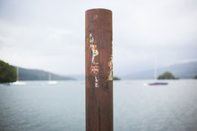 Rustic Pier Post On Banks Of Lake Windermere