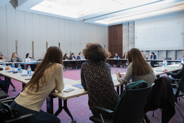 Business and Entrepreneurship. Panoramic composition suitable for banners. Speaker Giving a Talk at Business Meeting. Audience in the conference hall.