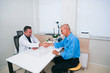 © qunica.com - Handshake between a doctor and his senior ( old ) patient.