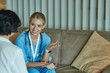© lenetsnikolai - Friendly smiling doctor and patient sitting on the couch. Very