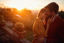 Romantic Man And Woman At Sunset. Smiling Man And Woman Is Enjoying Sunset