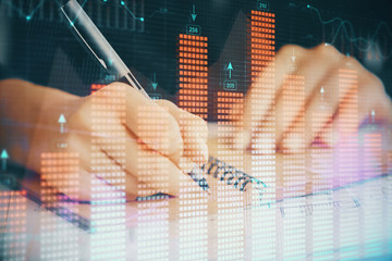 Forex chart displayed on woman's hand taking notes background. Concept of research. Double exposure