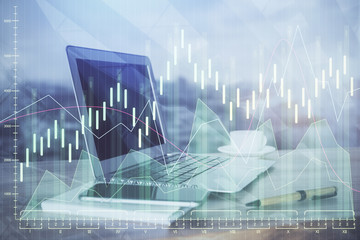 Double exposure of chart and financial info and work space with computer background. Concept of international online trading.