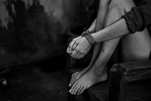 Sad Victim Woman Hands Tied By Red Rope. Abused And Tortured Concept. Sexual Abuse Or Rape With Copy Space Background For Text.