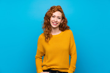 Wall Mural - Redhead woman with yellow sweater laughing