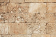 Old and weathered large stone blocks wall texture. Beige sandstone tones
