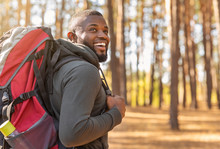 African Man Wearing Backpack Standing On Forest Trail