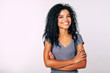 © My Ocean studio - Confidence, as it is. Close-up photo of young African American woman with medium-length wavy dark hair standing with folded arms looking at the camera and smiling broadly.