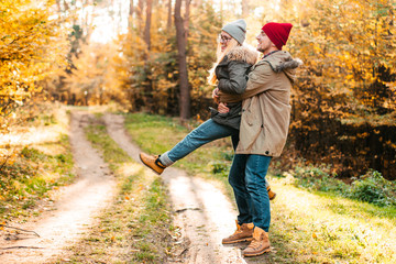 Traveler couple in love so fun in the forest. Concept of trekking, adventure and seasonal vacation.