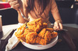 Close-up Fried chicken,freshfast on plate with fried chicken blur background,Woman eating fried chicken,Hungry,diet,Fat food,healthy food