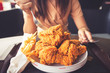 Close-up Fried chicken,freshfast on plate with fried chicken blur background,Woman eating fried chicken,Hungry,diet,Fat food,healthy food