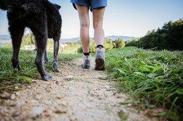 Wall Mural - Low angle view of a woman in hiking shoes on footpath