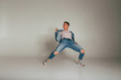 © Skripnik Olga - shot of mad, crazy, cheerful, successful, lucky guy in casual outfit, jeans, jumping with hands up,triumphant, gesturing against white background