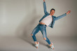 © Skripnik Olga - shot of mad, crazy, cheerful, successful, lucky guy in casual outfit, jeans, jumping with hands up,triumphant, gesturing against white background