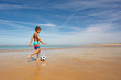 Young boy with soccer ball play on sea beach