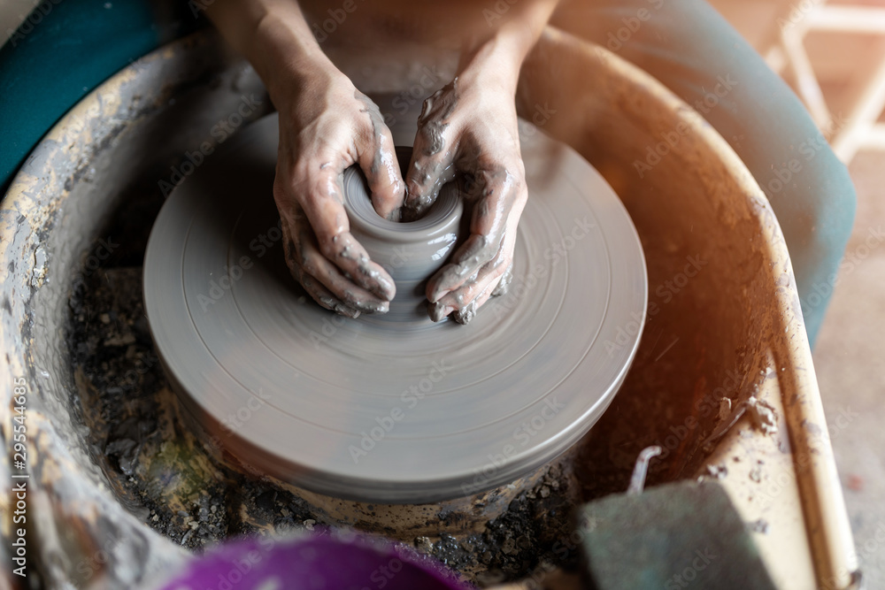 Woman making ceramic work with potter's wheel - obrazy, fototapety, plakaty 