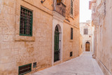 Fototapeta Perspektywa 3d - Narrow street in the fortified city Mdina in the Northern Region of Malta