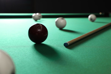 Balls and cue on modern billiard table