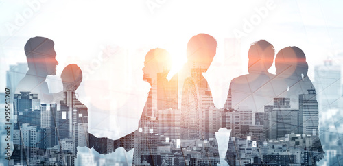 Fotomural Double exposure image of many business people conference group meeting on city office building in background showing partnership success of business deal