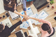© InfiniteFlow - Businessmen and businesswomen joining hands in group meeting at multicultural office room showing teamwork, support and unity in business. Diversity workplace and corporate people working concept.