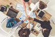 © InfiniteFlow - Businessmen and businesswomen joining hands in group meeting at multicultural office room showing teamwork, support and unity in business. Diversity workplace and corporate people working concept.
